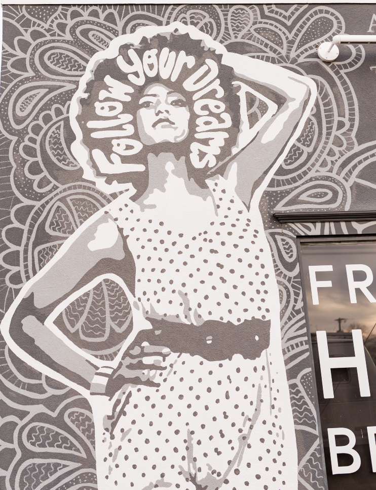 Follow your dreams Follow Your Dreams. Woman on side of building. Empowerment